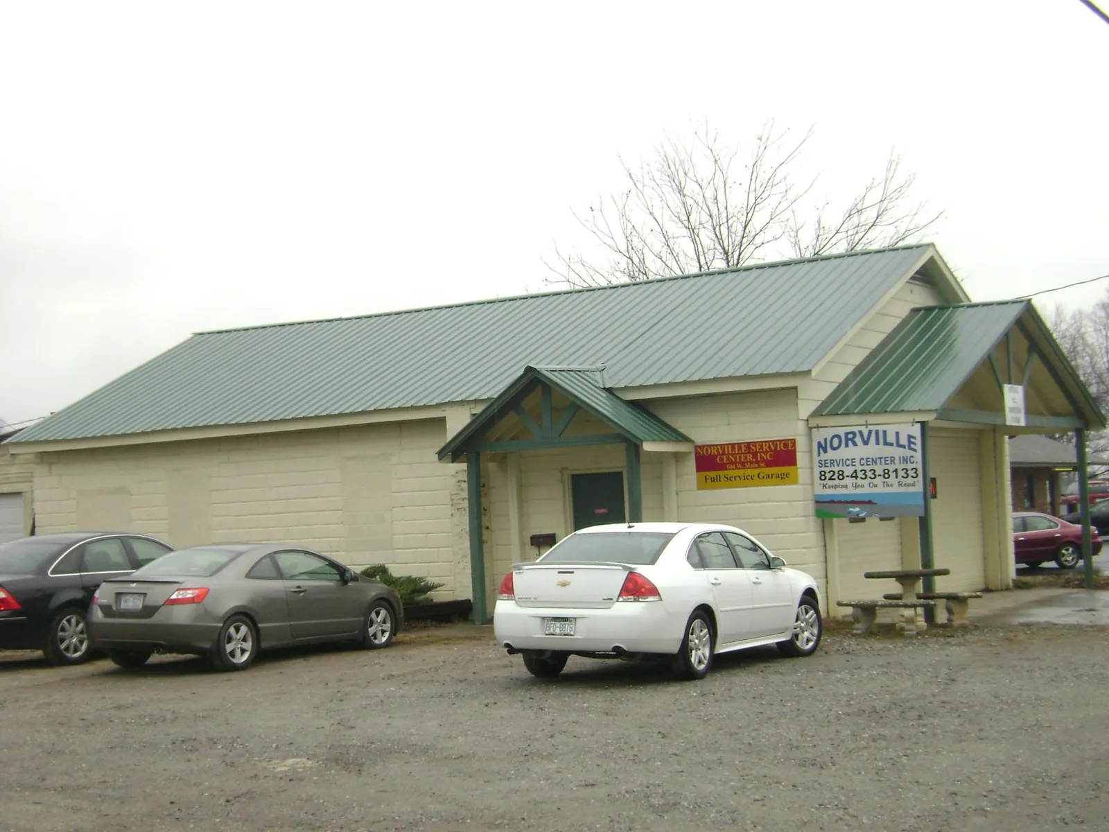 Green metal roof on a service garage with a covered entry in Blair